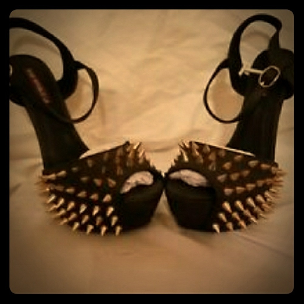 Black platform stilettos with gold spike accents